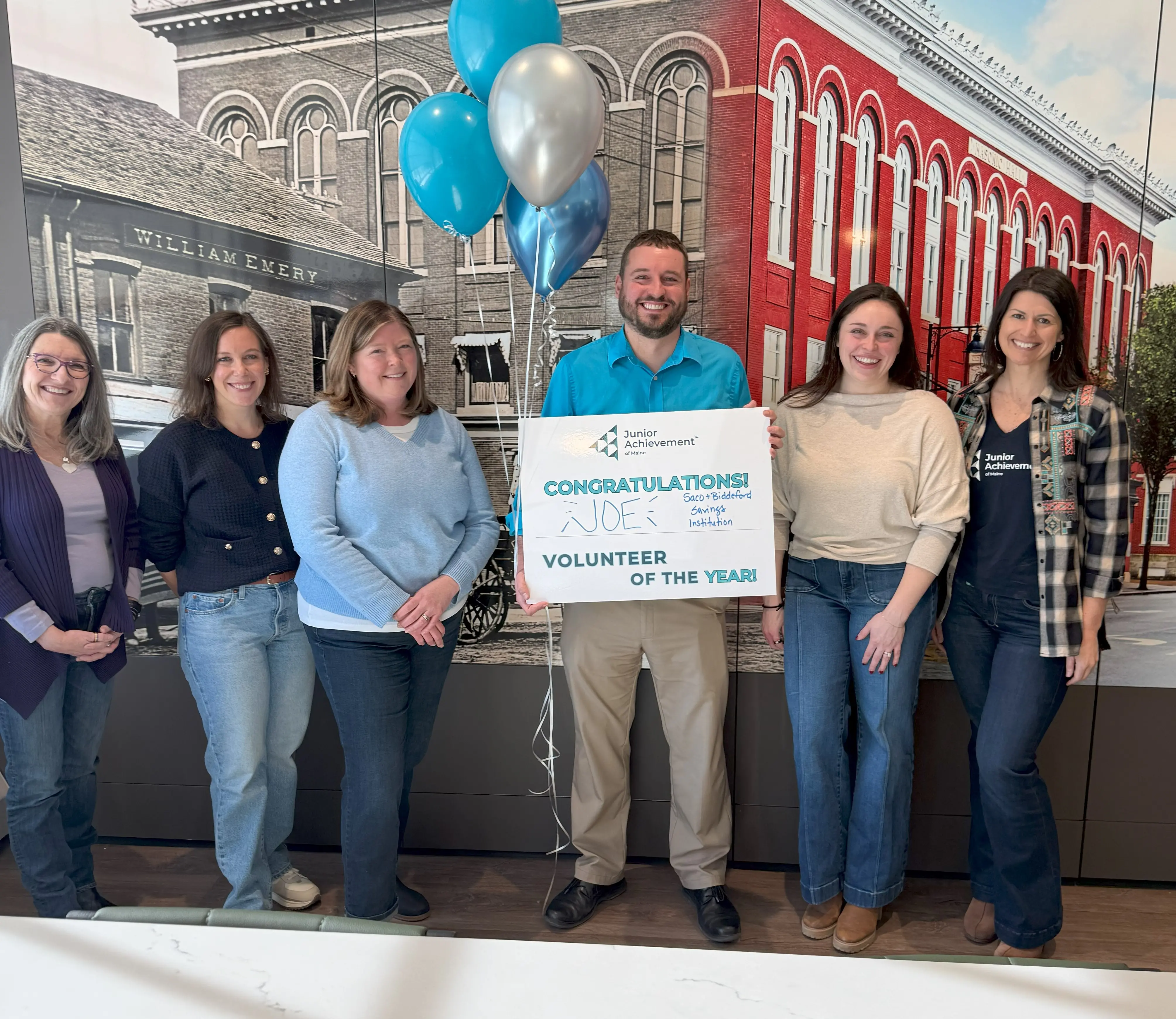 Group of people holding a sign